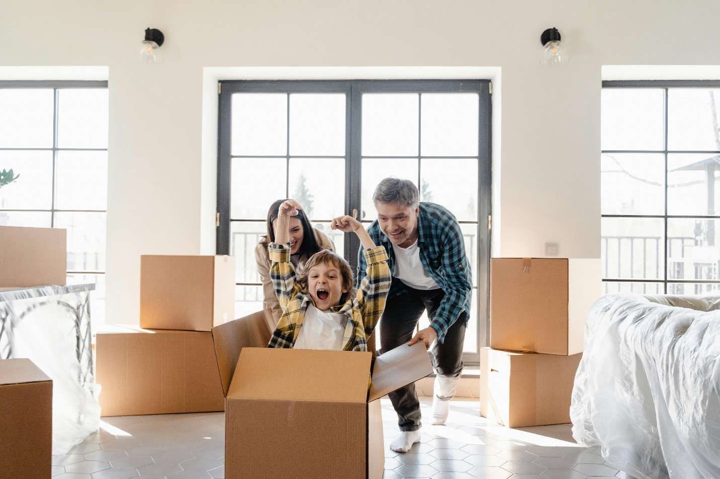 A Joyful Family Moment in a New Home Filled with Moving Boxes