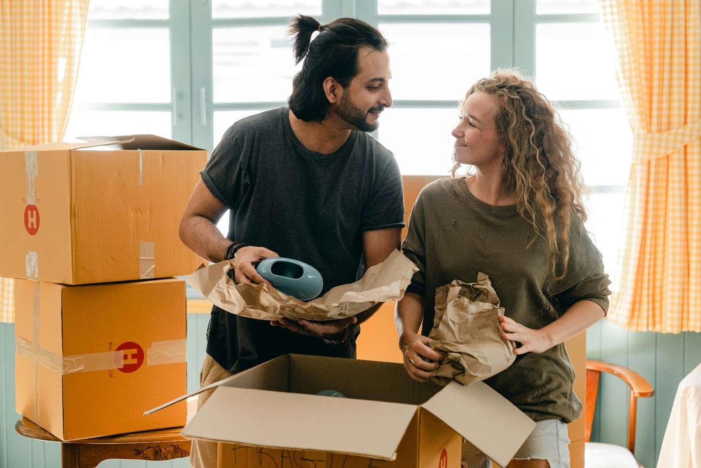A Happy Couple Packing Boxes for a Move