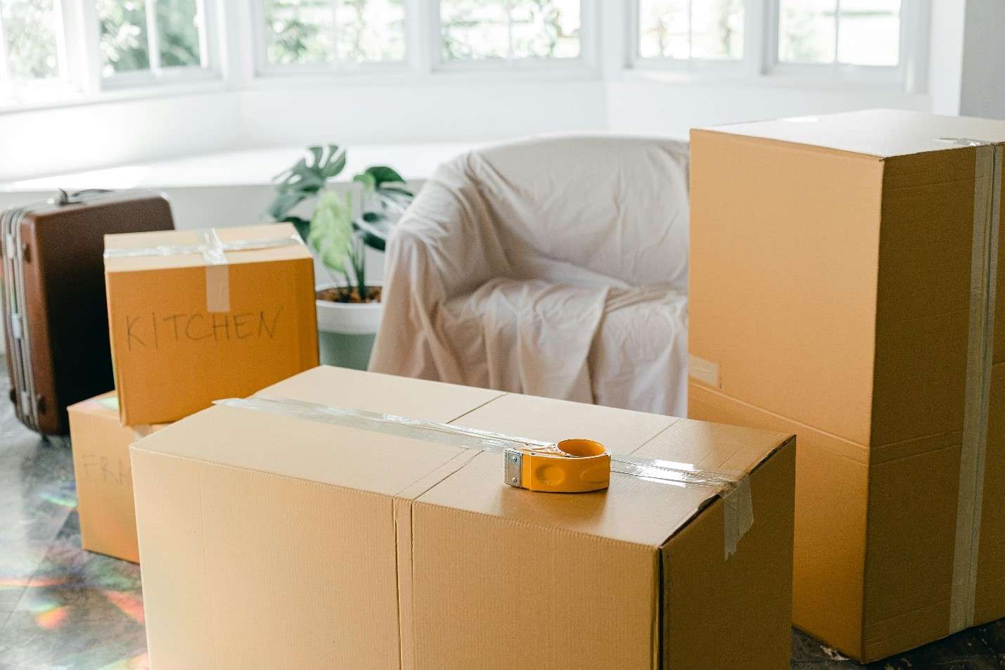 A Bright, Airy Room Filled with Moving Boxes of Various Sizes