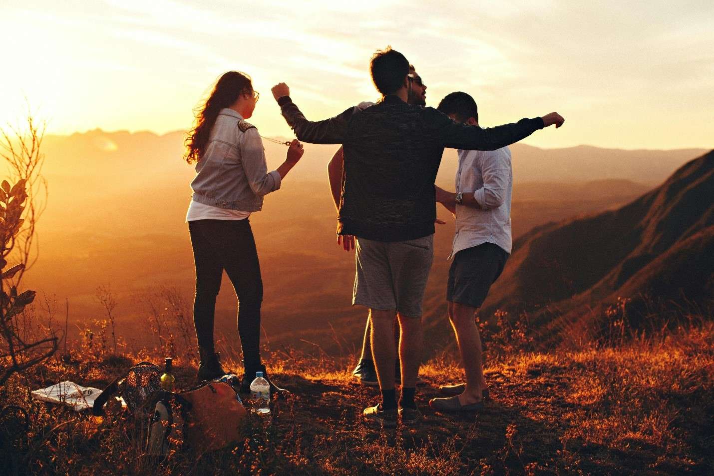 Three Friends Enjoying a Breathtaking Sunset on a Mountain in Tampa