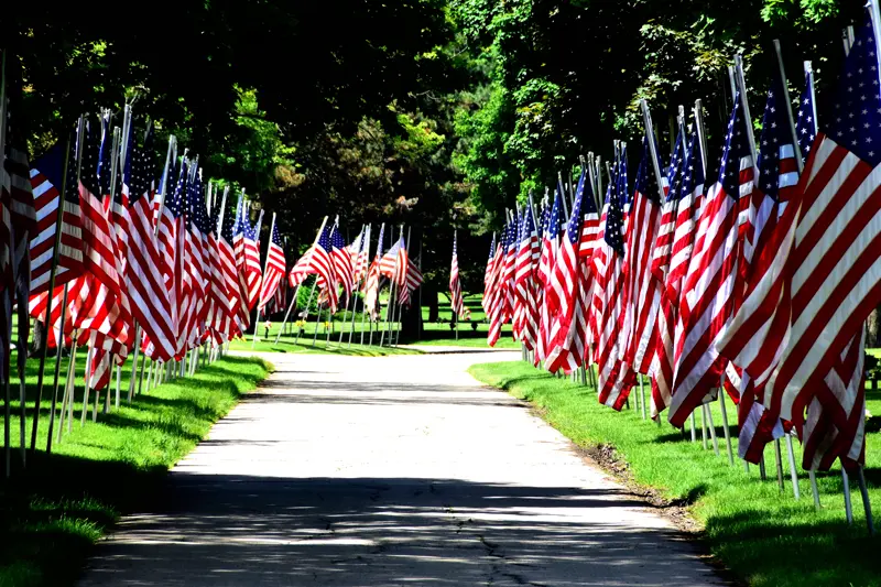 American flags lining a road — we move service members with honor