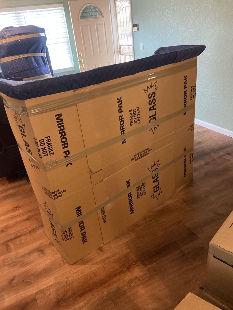 Furniture wrapped in moving blankets and shrink wrap